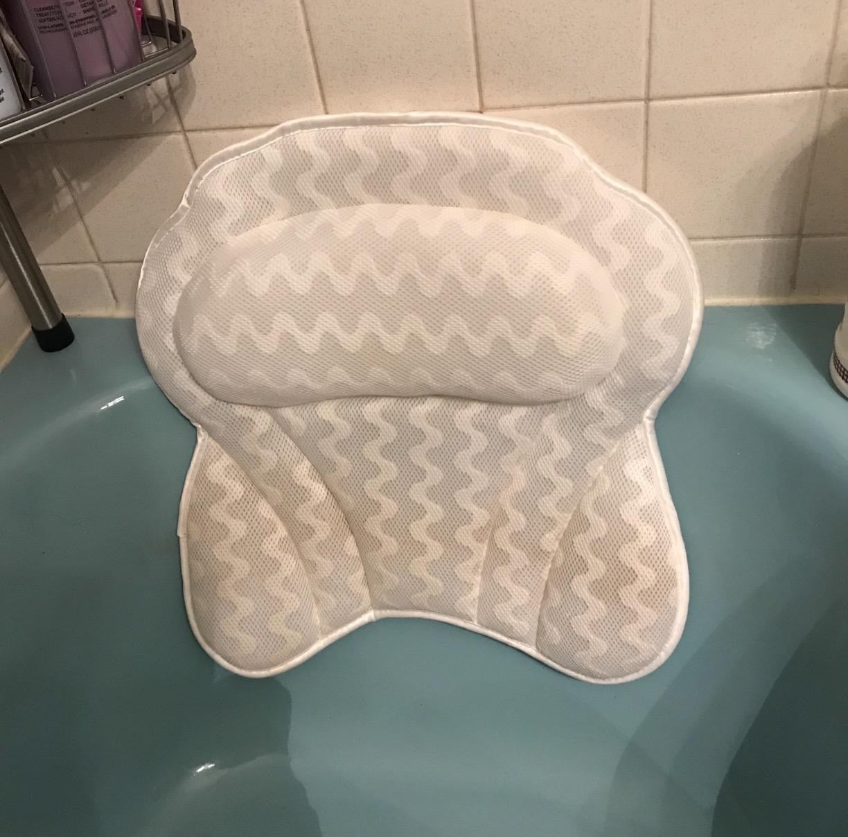 The pillow suctioned to a blue tub