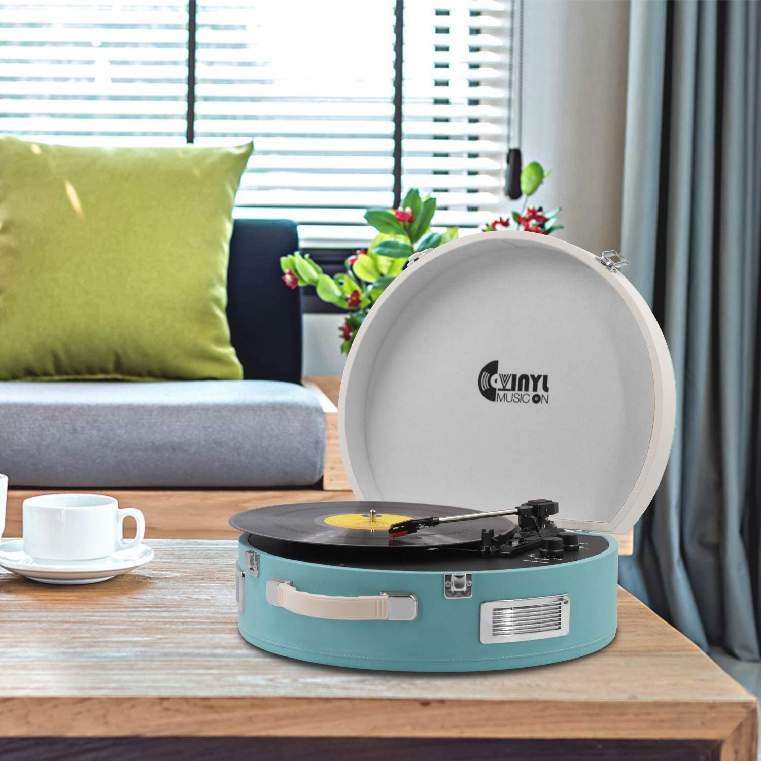 A record player sitting on a low table