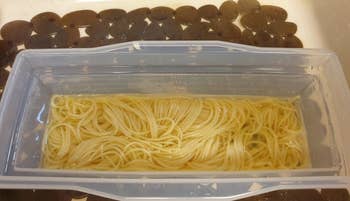 A photo from the same reviewer of cooked pasta and water in the clear, plastic microwave pasta cooker 