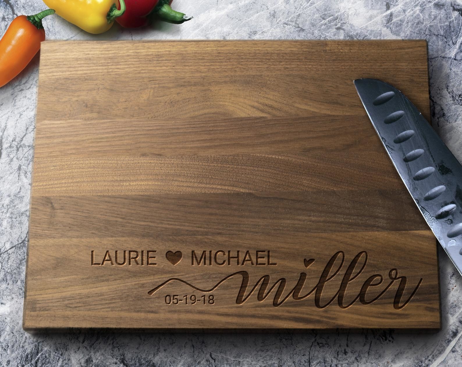 the cutting board with Laurie and Michael Miller, 5-19-18 engraved into it