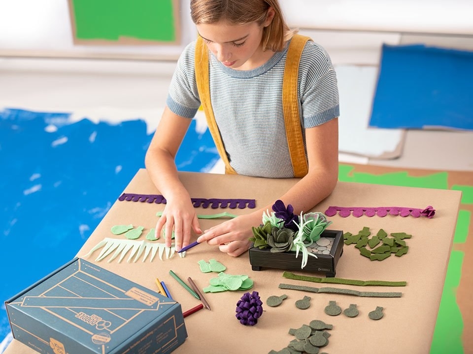 Child working on felt succulent kit