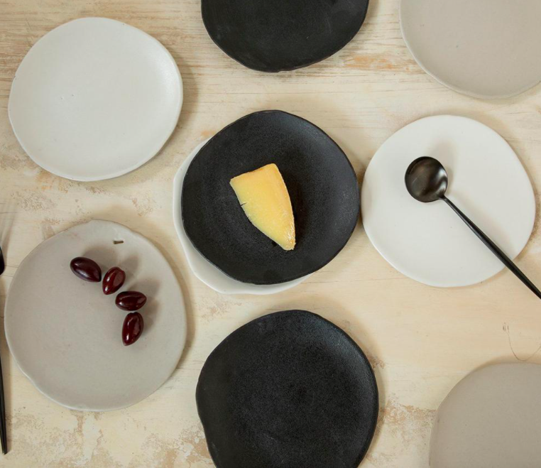 A flatlay of several handmade ceramic plates