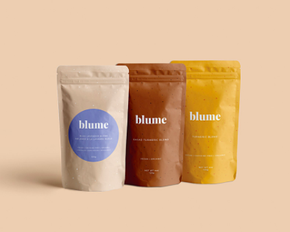 A trio of paper bags containing the latte mixes on a simple background
