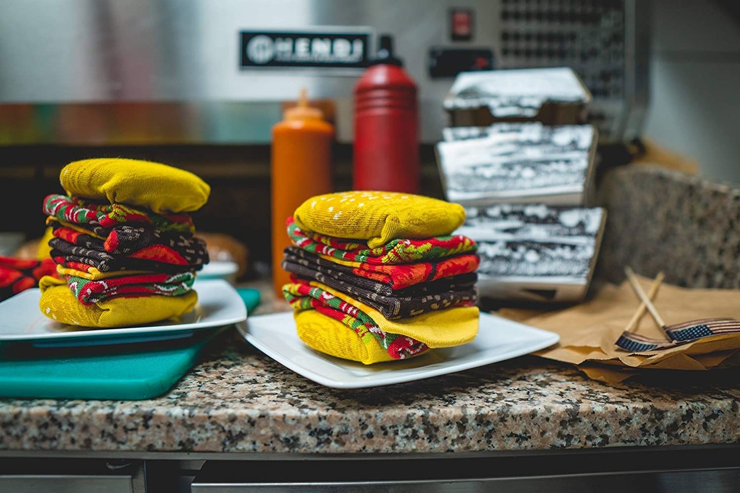 The burger socks made to look like a burger with yellow, green, red and brown fabric colors