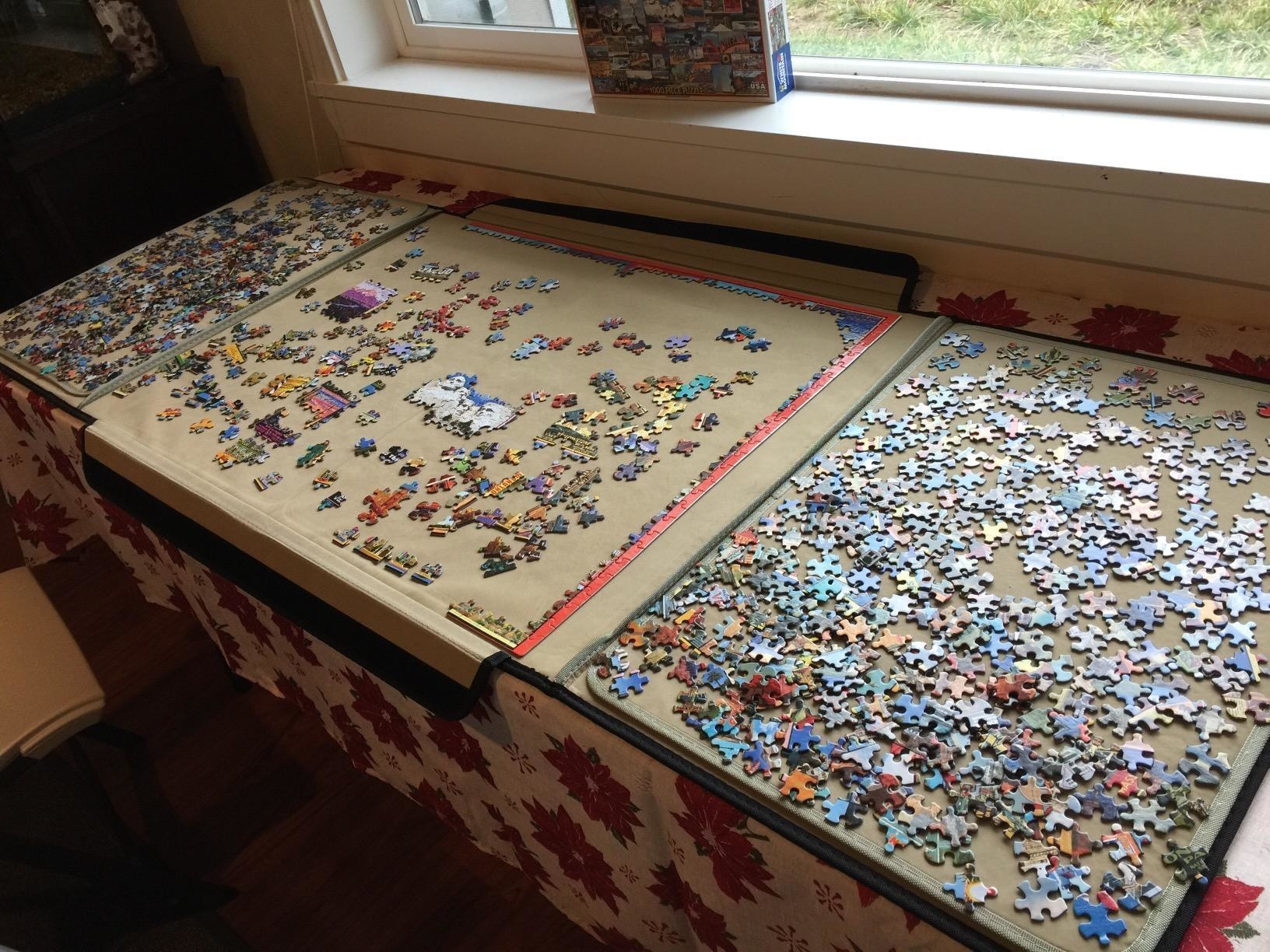 Reviewer&#x27;s puzzle board spread out with puzzles pieces on it