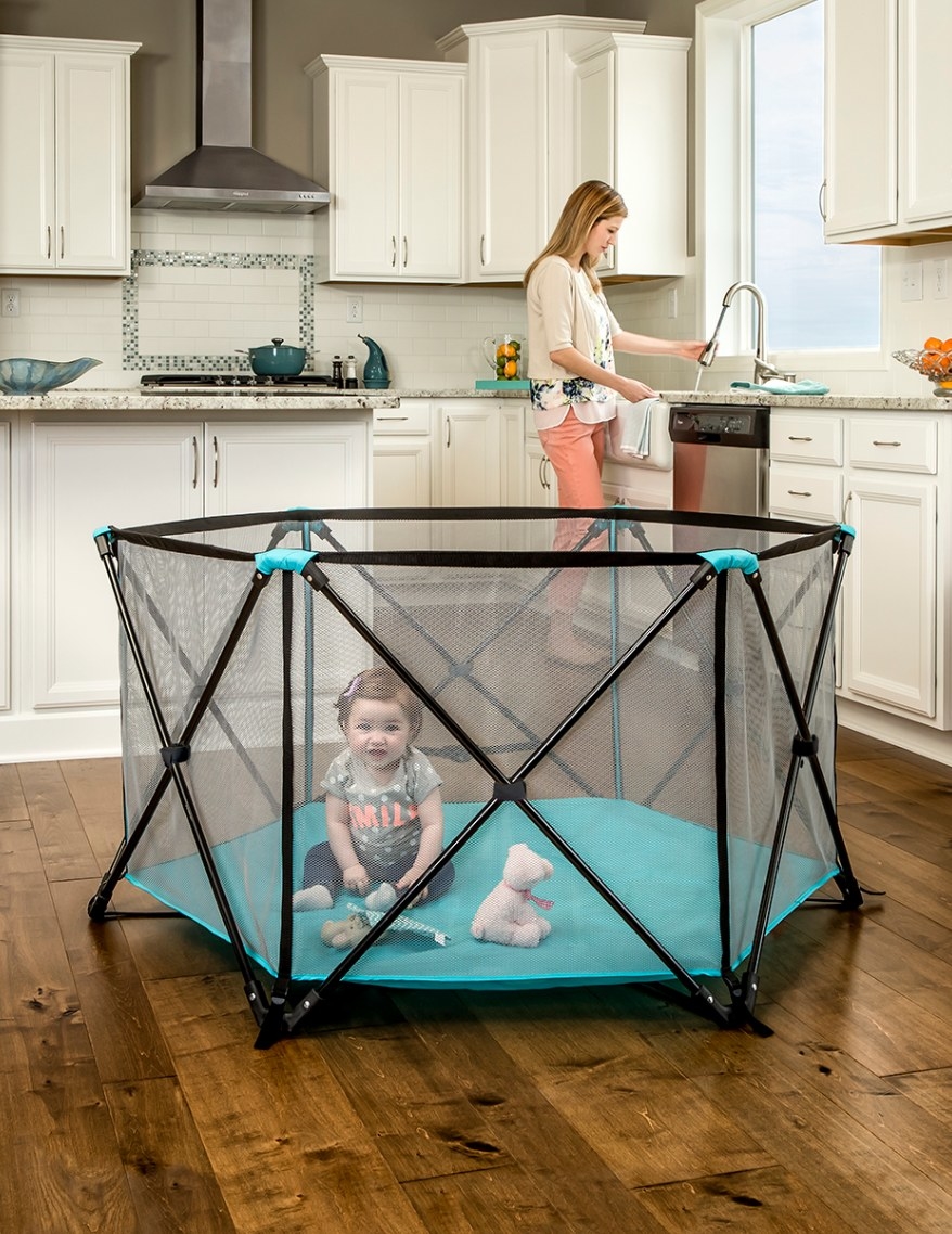 The portable play yard in black and blue