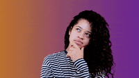 Ella Mai contemplates with her hand on her chin. 