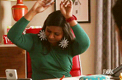 Mindy swaying her hands in the air happily
