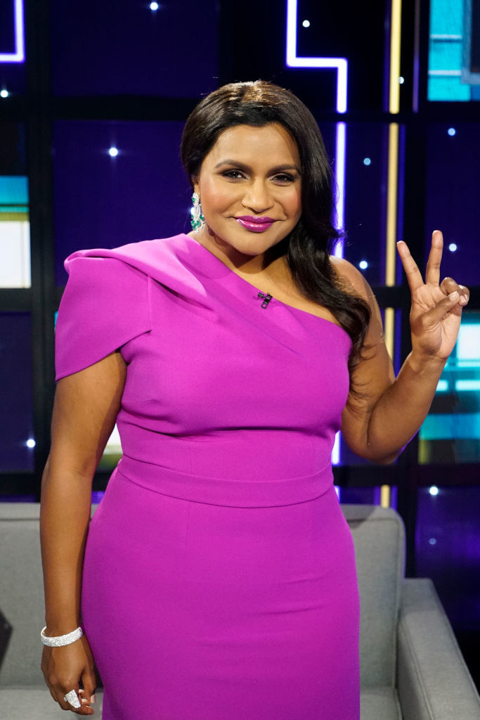 Mindy throwing up the peace sign with her hand