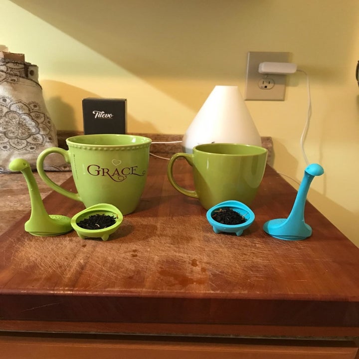 reviewer image of the tilevo tea infusers open and with tea leaves in them