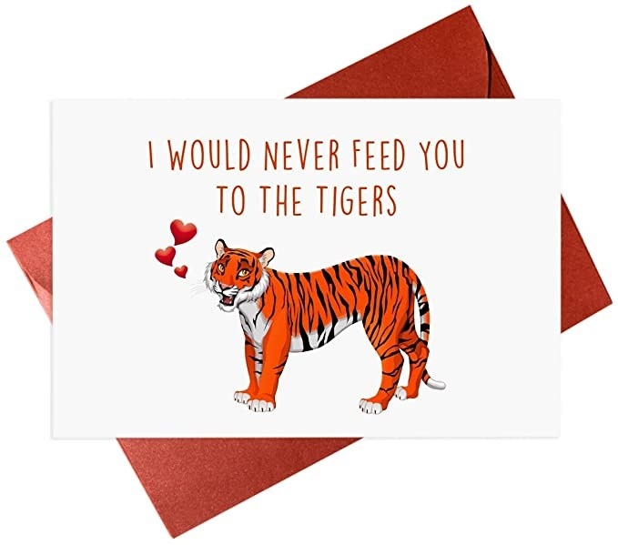 A white card with a drawing of a tiger and &quot;I would never feed you to the tigers&quot; in orange type