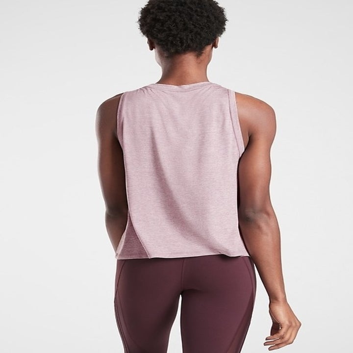 A model wearing the shirt in soft pink