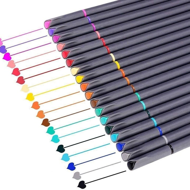 the full pack of pens arranged in a straight line by color