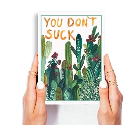 A white card with succulent plants painted on it, and "You don't suck" in yellow-brown