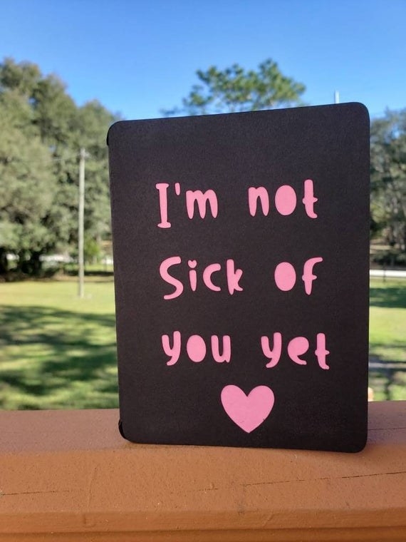 A black card with pink cut-out reading "I'm not sick of you yet"