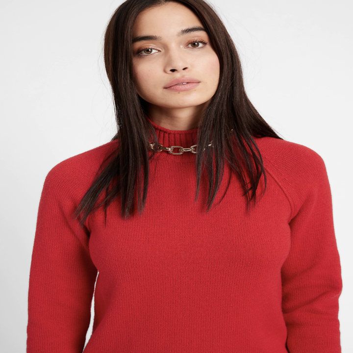 Model wearing chunky mock-neck sweater in the shade pure red