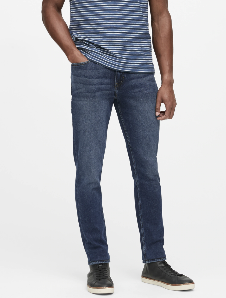 Model wearing slim legacy jean in the shade medium wash