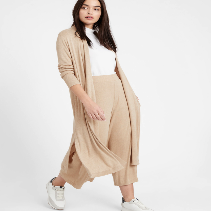 Model wearing ribbed duster cardigan in the shade camel