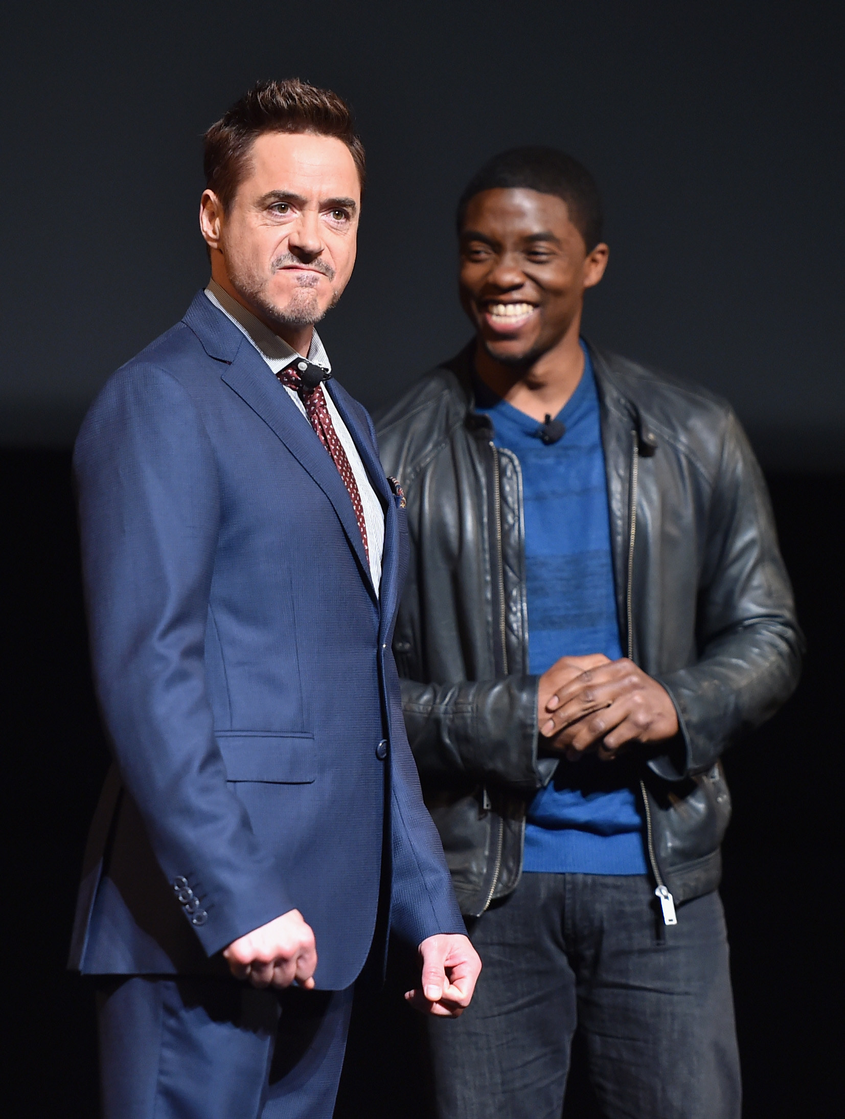 Robert Downey Jr. grunts and Chadwick Boseman laughs on stage together