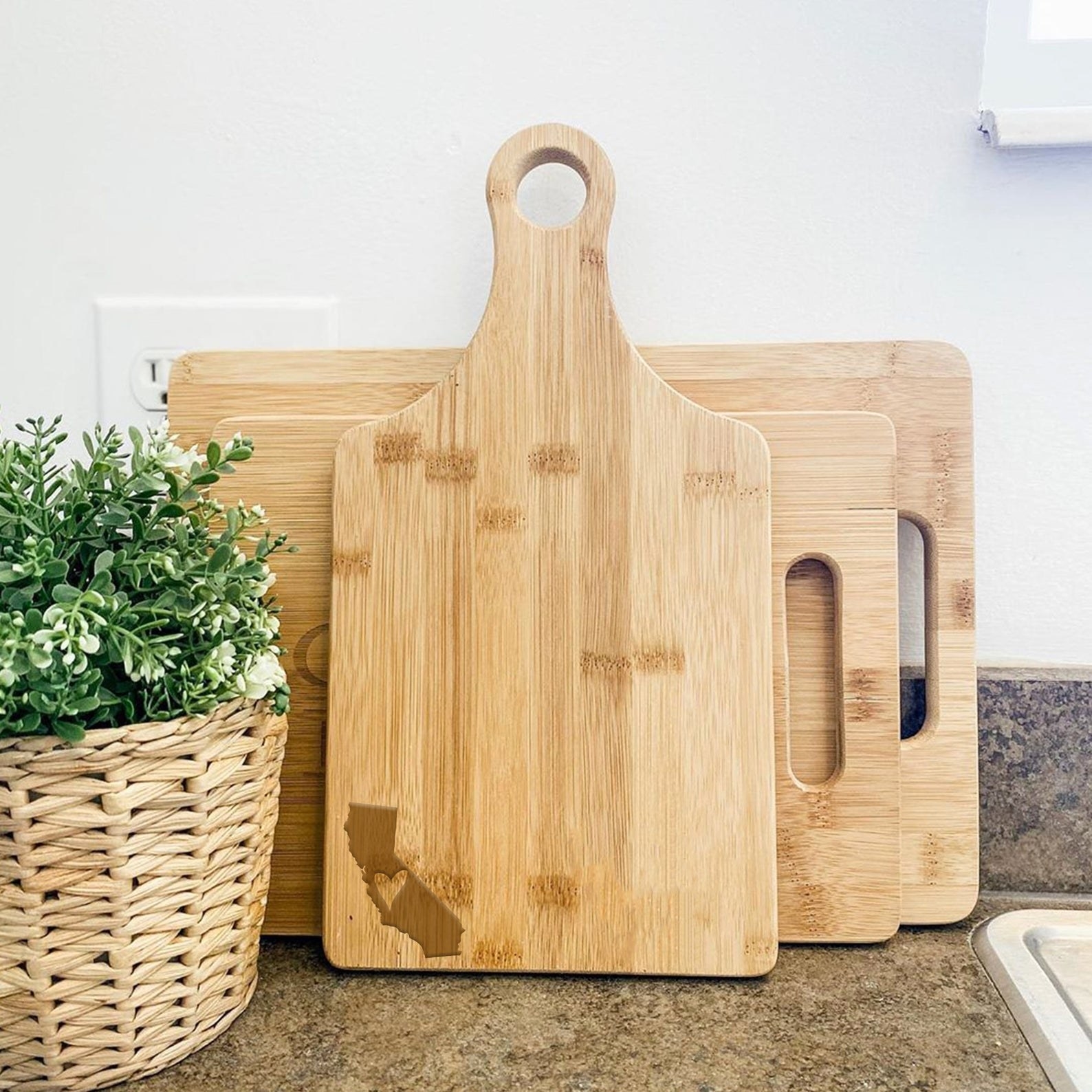 The paddle cutting board with a California silhouette in the corner
