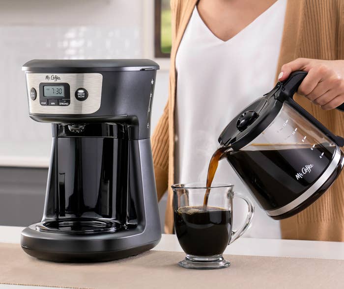 coffee maker on counter and woman pouring coffee from pot