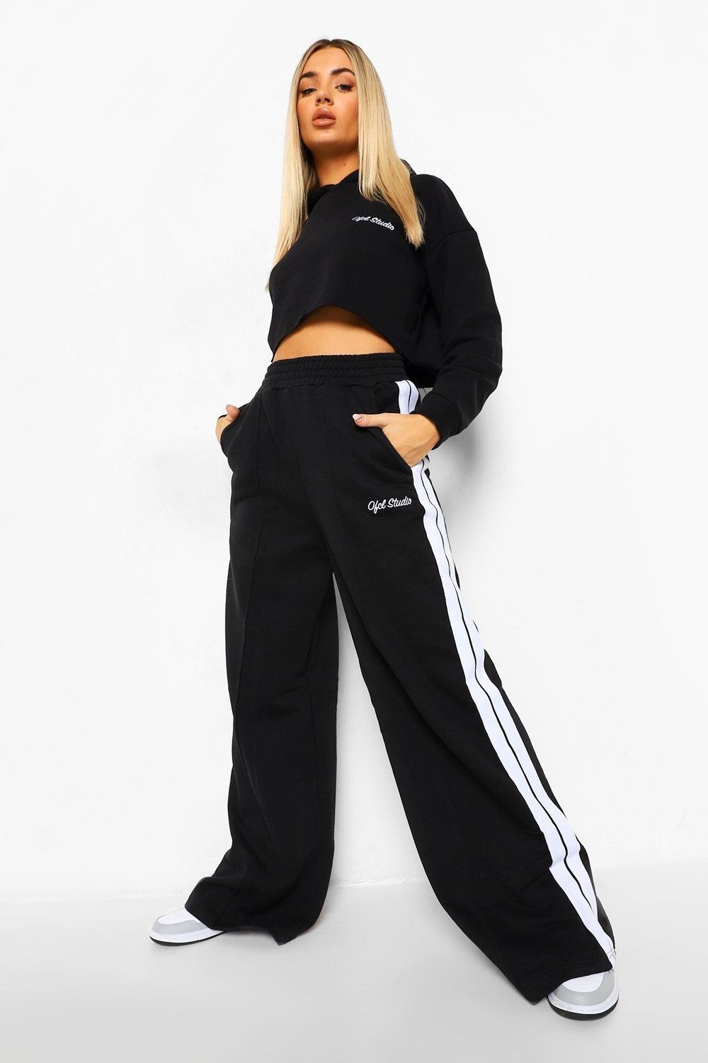 Model wearing black and white-striped tracksuit