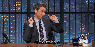 Seth Meyers pointing towards the door and saying &quot;get outta here.&quot;