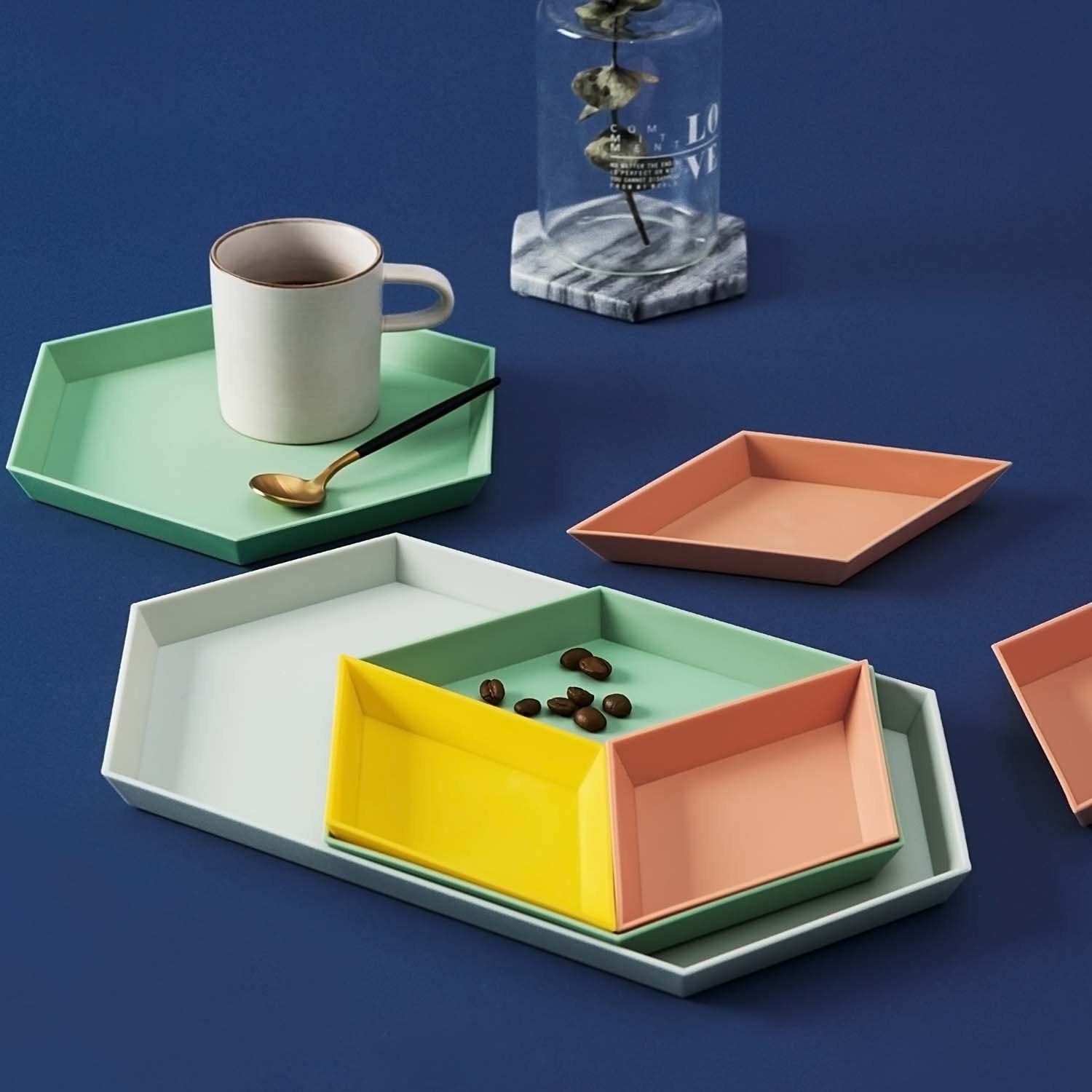 the full set of trays holding a mug and a few coffee beans