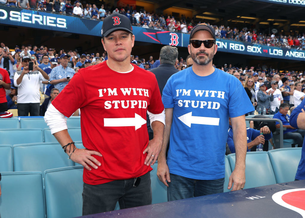 Matt Damon and Jimmy Kimmel wearing matching t-shirts that read &quot;I&#x27;m with stupid&quot; at a Red Sox game in the late 2010s