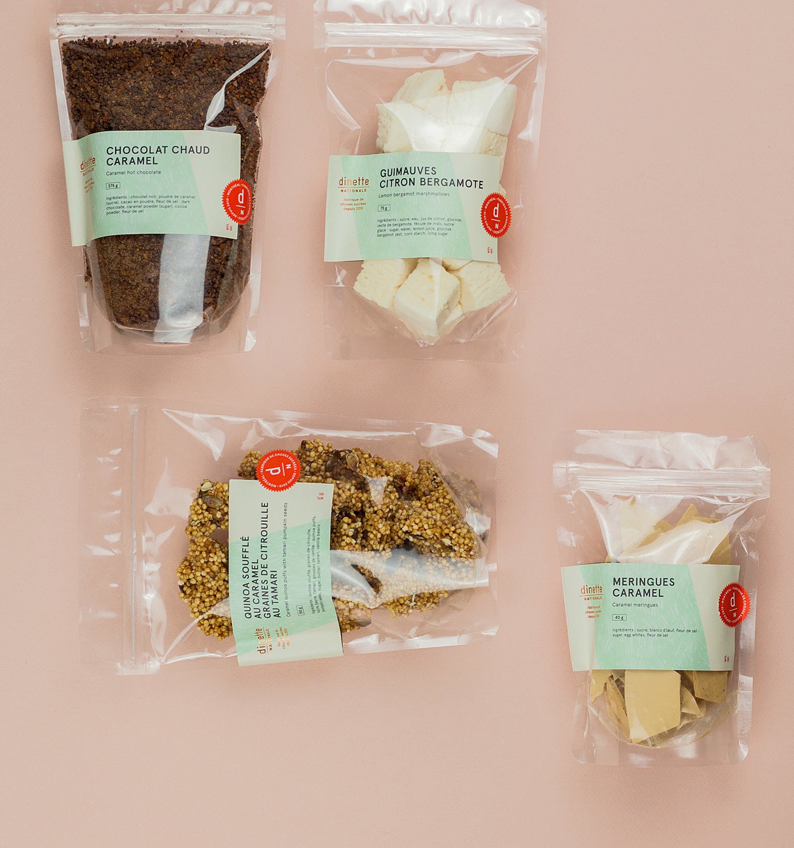Four packages of food on a plain background