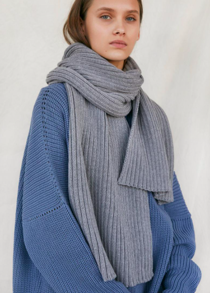 A person wearing the thick scarf with an oversized sweater