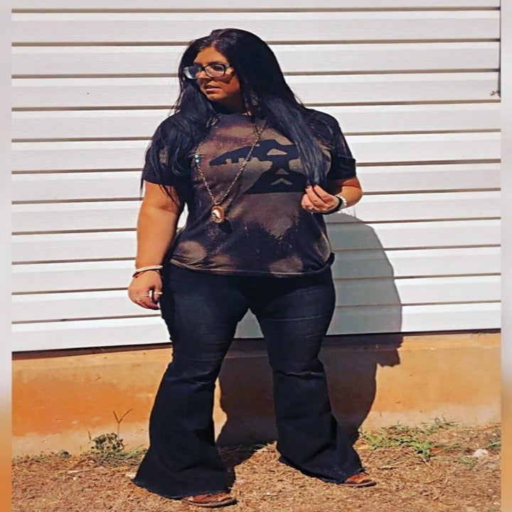 A different reviewer wearing the pants in a black denim