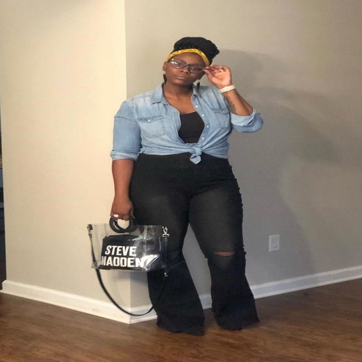 Reviewer wearing the jeans in a dark denim