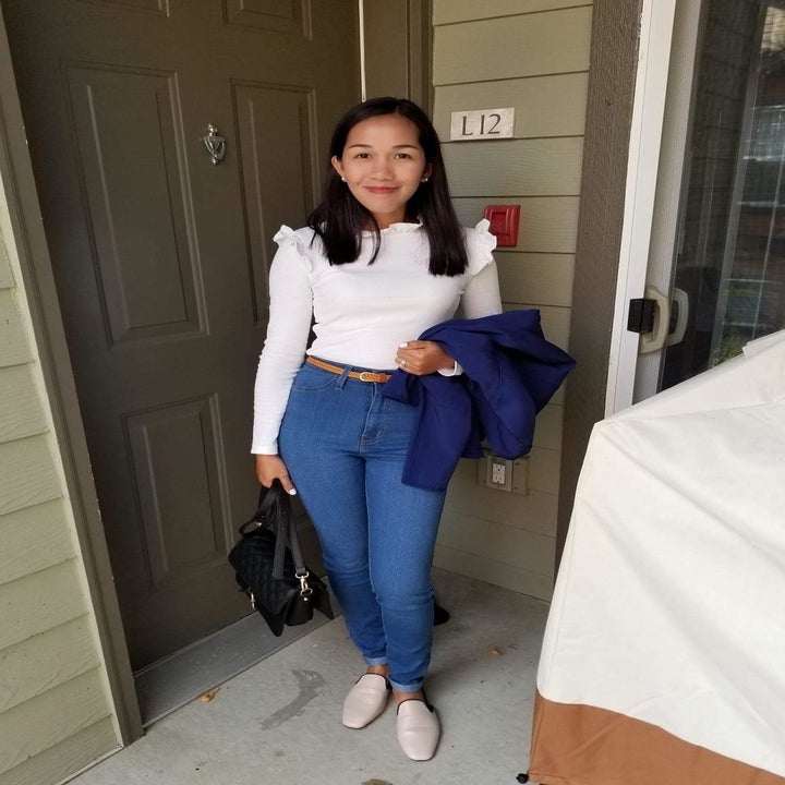 Reviewer wearing the fitted crewneck shirt with ruffles on the sleeves in white