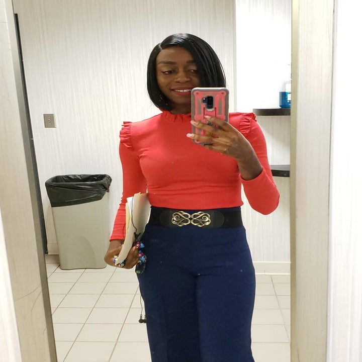 A different reviewer wearing the shirt in orange