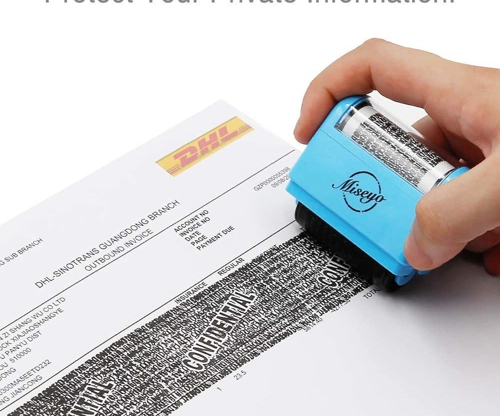 person rolling the stamp across a piece of paper 