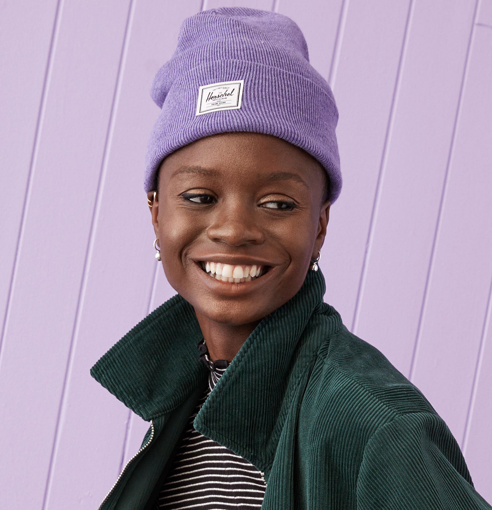 A person wearing the Herschel beanie and smiling