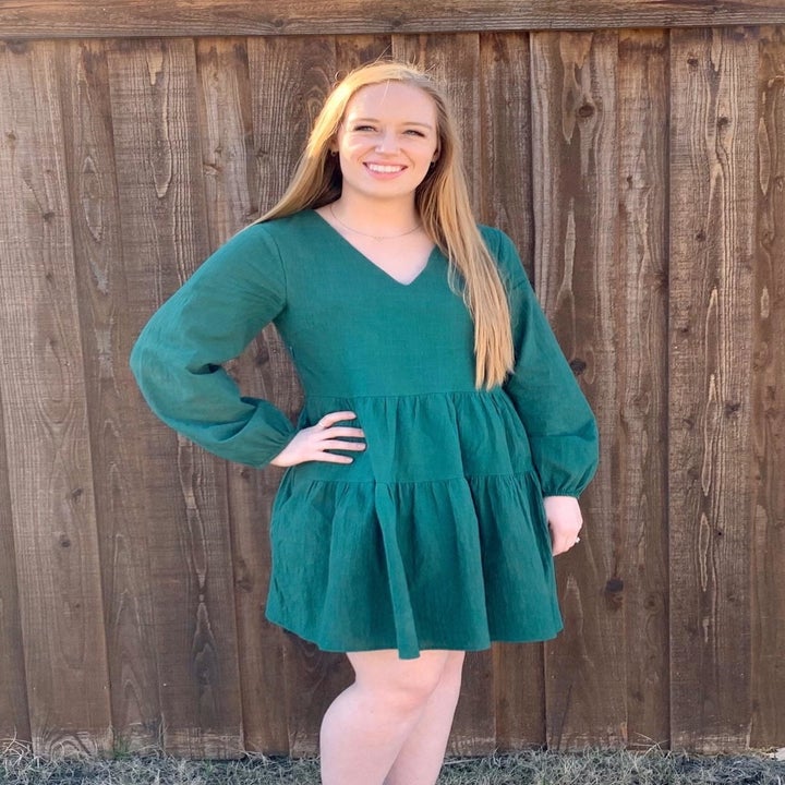 A different reviewer wearing the knee-length dress in green
