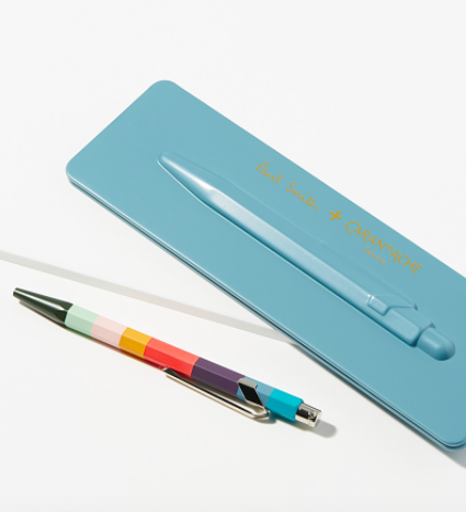 A flatlay of the colourful, angular pen next to it&#x27;s case