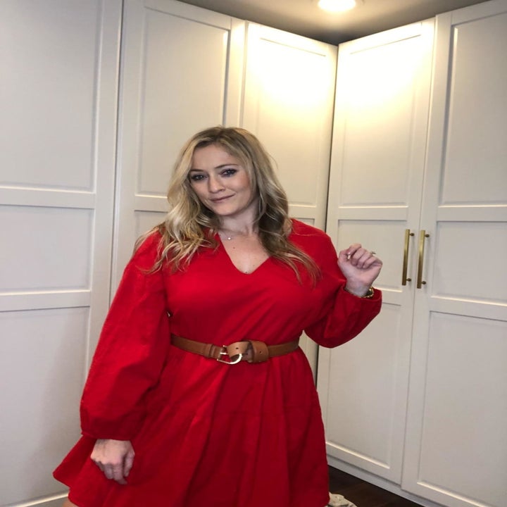 Reviewer wearing the long-sleeved dress in bright red