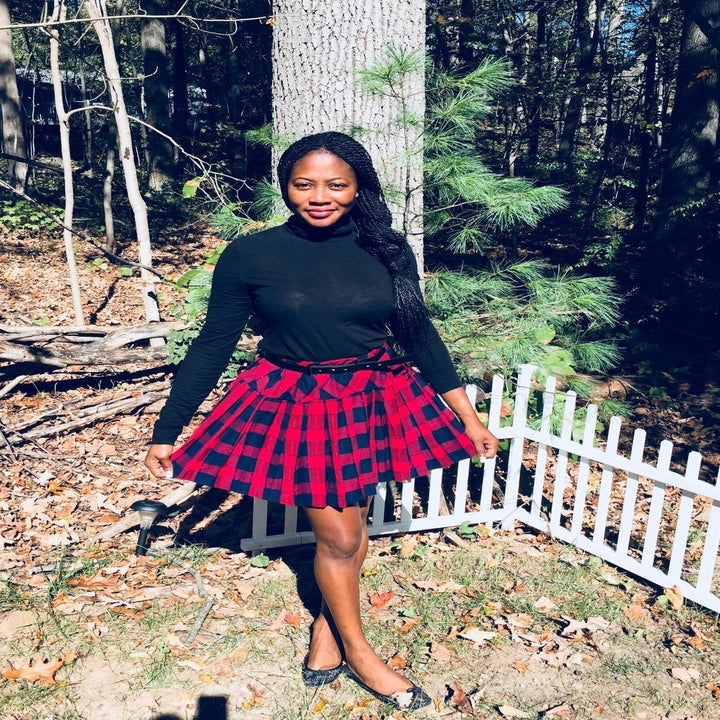 Reviewer wearing the mid-thigh length skirt in blue and red plaid