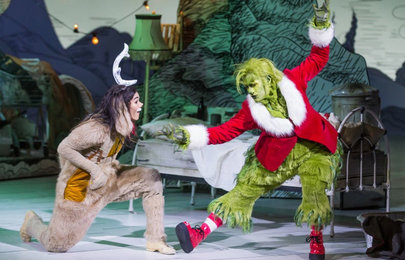 Matthew Morrison as the Grinch dancing and Booboo Stewart as Max the dog listening to him sing.