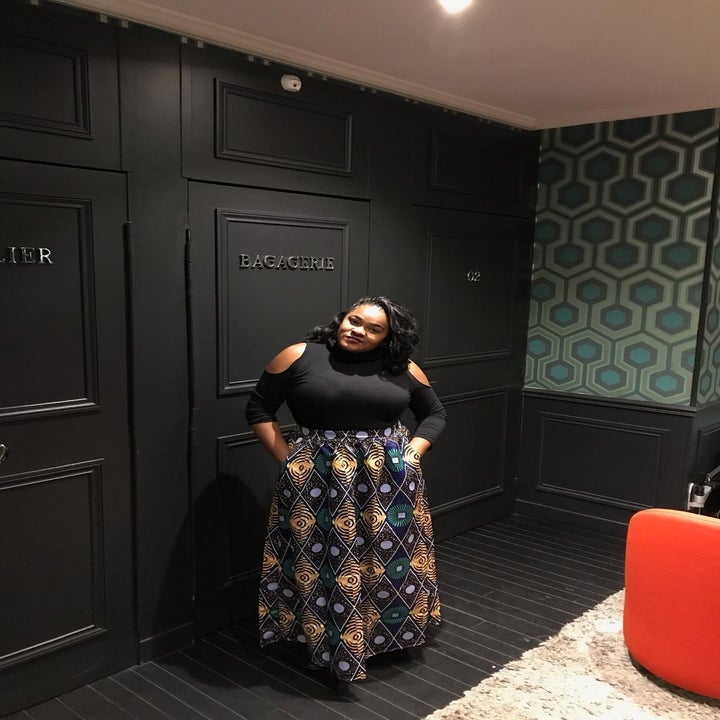 Reviewer wearing the skirt with a purple, yellow, and blue print