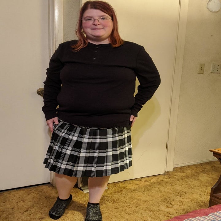 A different reviewer wearing the skirt in black and white plaid