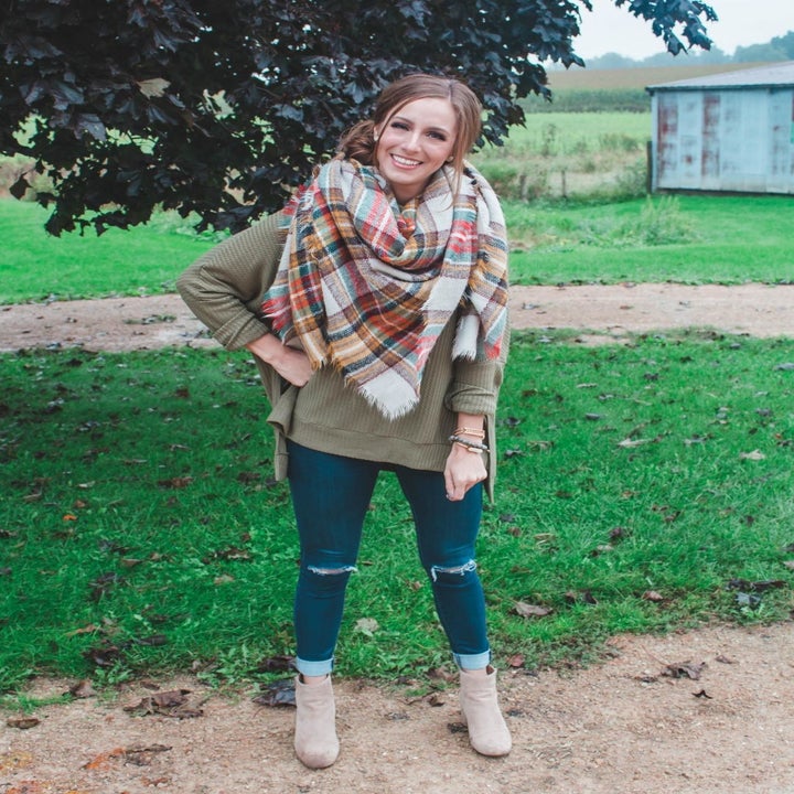 A different reviewer wearing the sweater in olive green