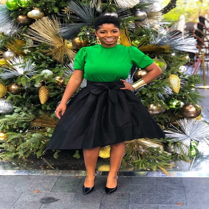 A different reviewer wearing the blouse in green
