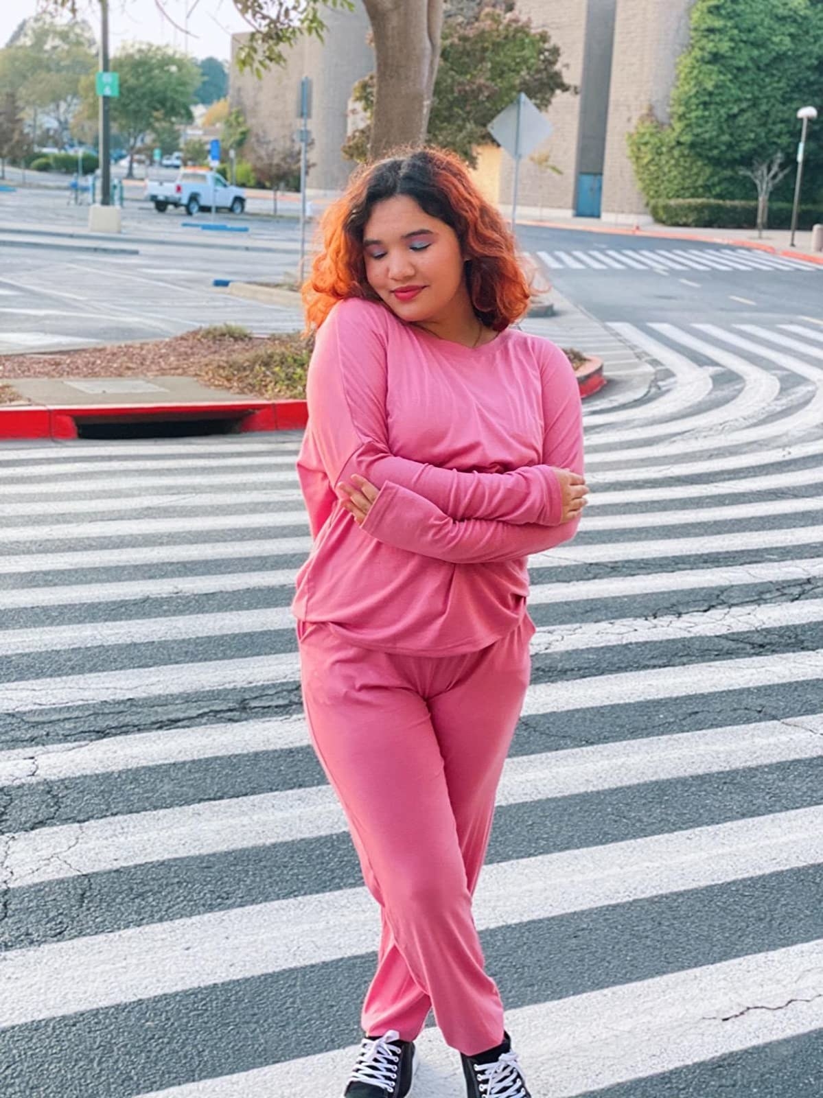 Reviewer wearing the long-sleeved and long pants sweatsuit in pink