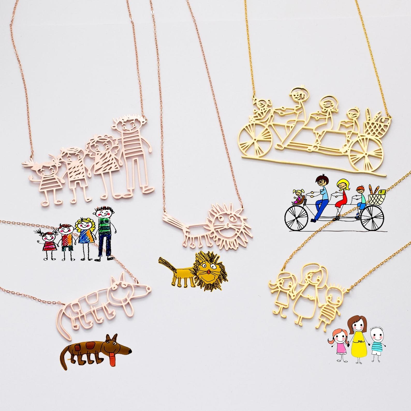 five different necklaces with the original kids&#x27; drawing right beside it. Two are gold and three are rose gold. Three are family drawings and two are drawings of animals.