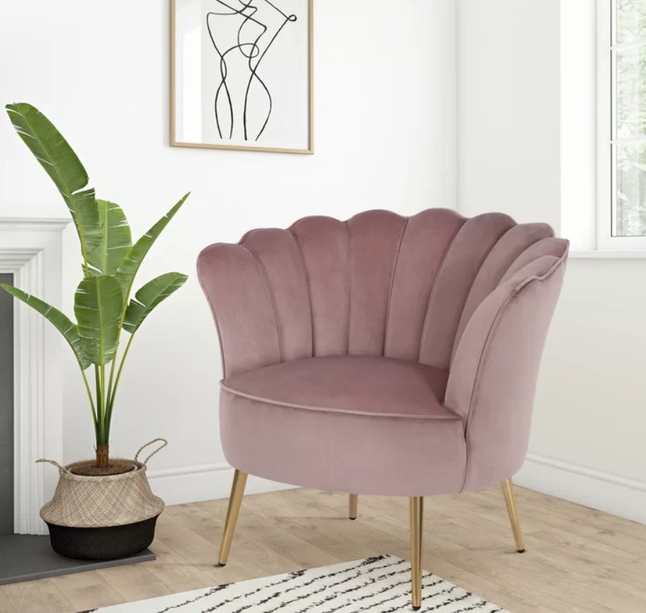 Velvet blush-colored seashell chair with gold legs