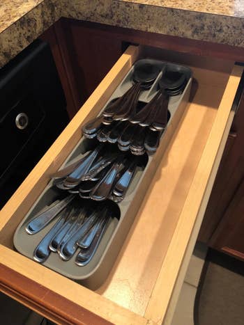 A reviewer's cutlery organizer placed in a small kitchen drawer